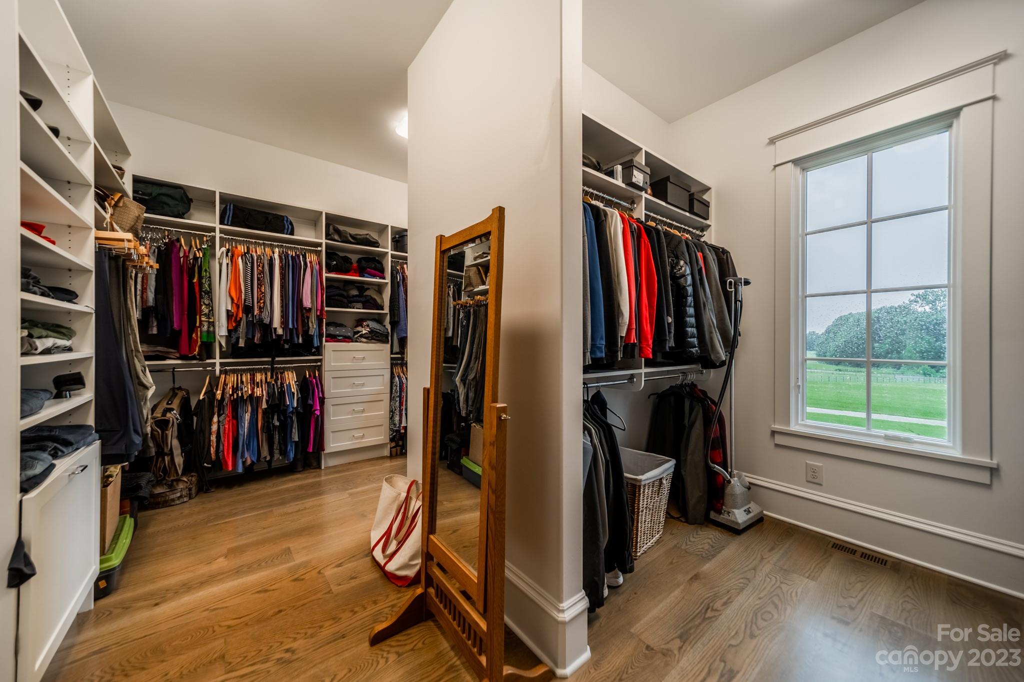 721 Lester Davis Road Waxhaw, NC 28173 - Photo 30 of 48 a view of walk in closet with clothes and shoes