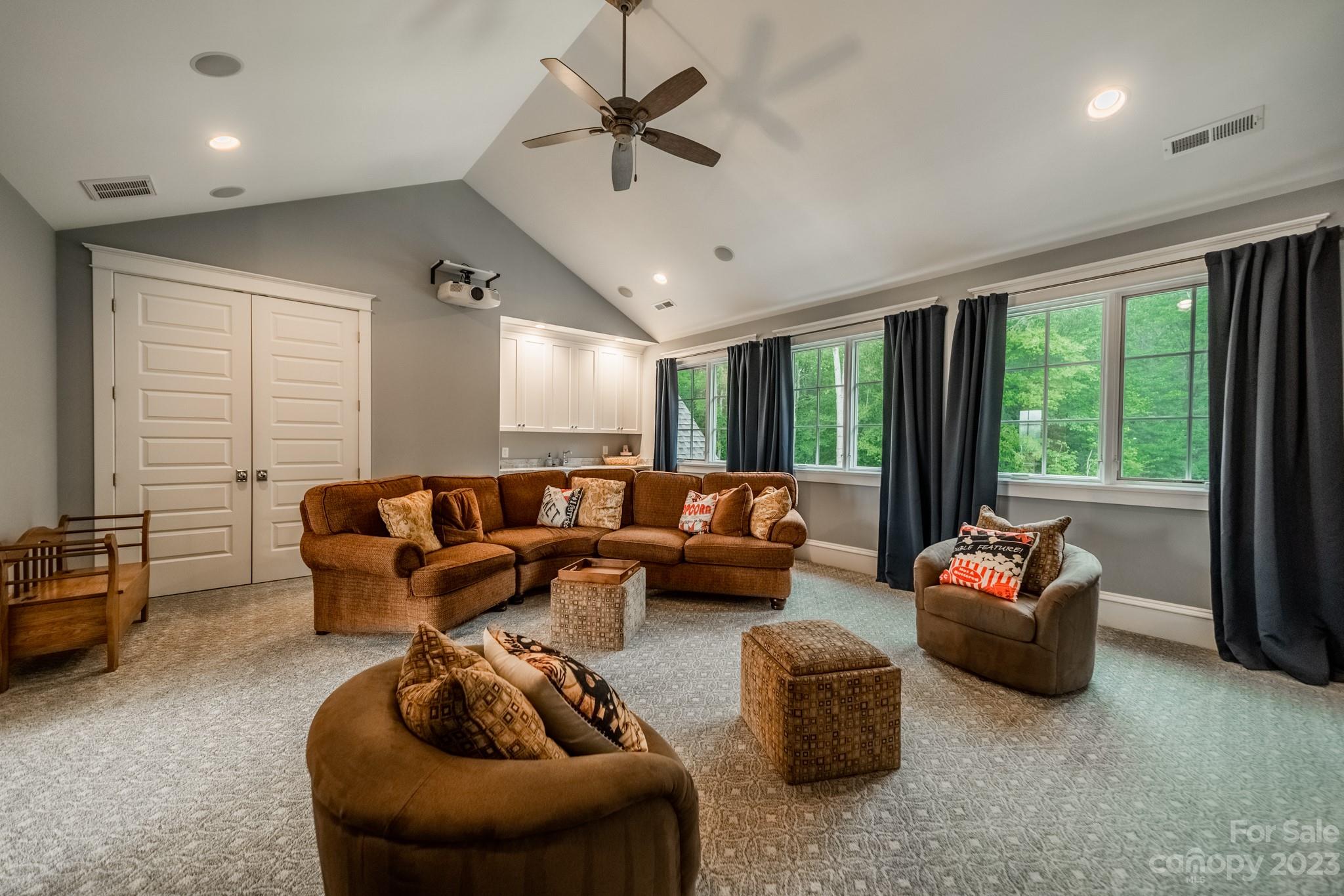 721 Lester Davis Road Waxhaw, NC 28173 - Photo 32 of 48 a living room with furniture ceiling fan and a floor to ceiling window