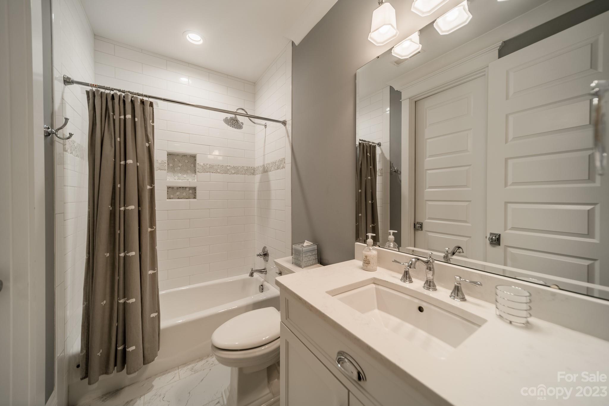 721 Lester Davis Road Waxhaw, NC 28173 - Photo 35 of 48 a bathroom with a double vanity sink toilet mirror and shower