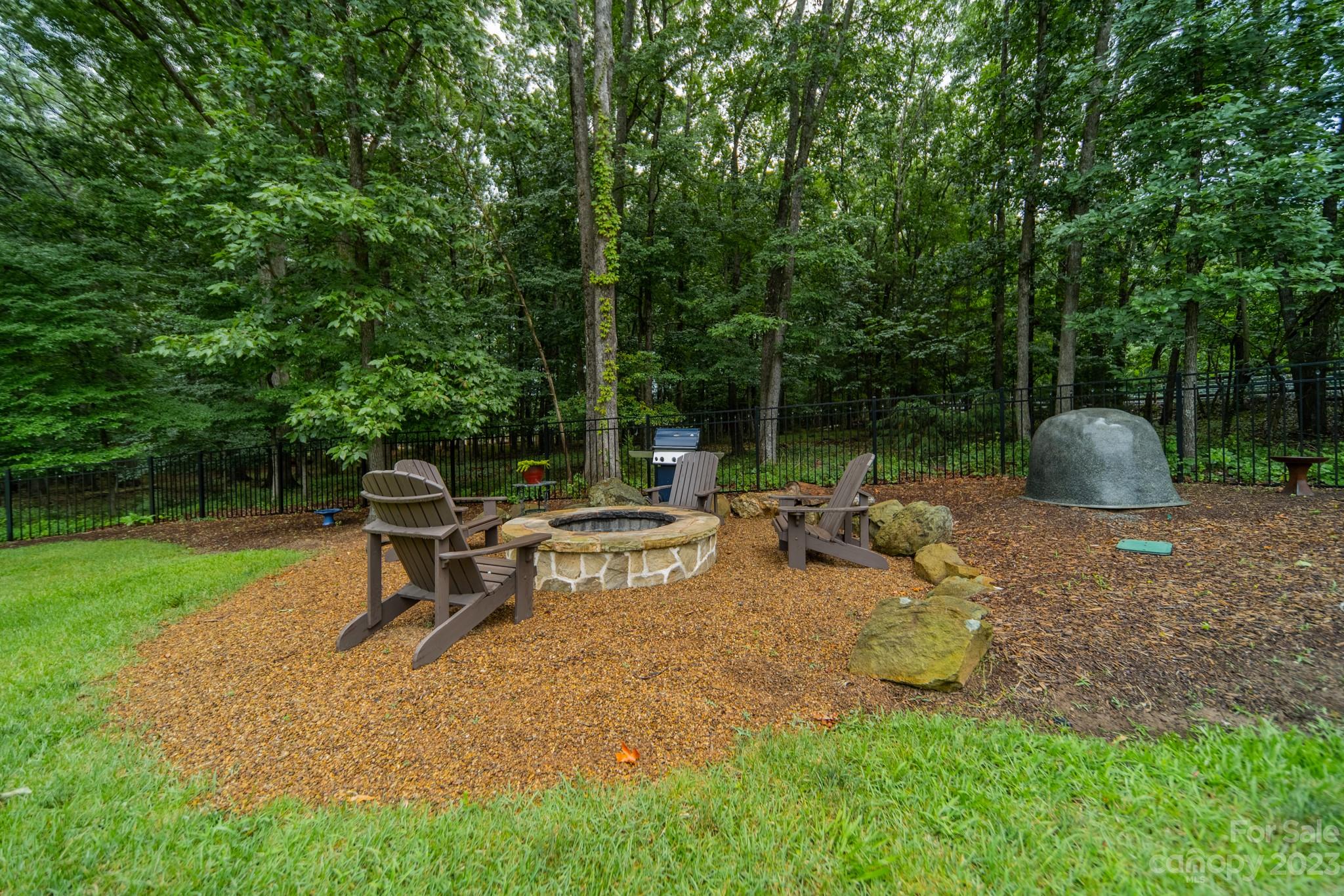 721 Lester Davis Road Waxhaw, NC 28173 - Photo 45 of 48 a view of a bench in the garden near a lake