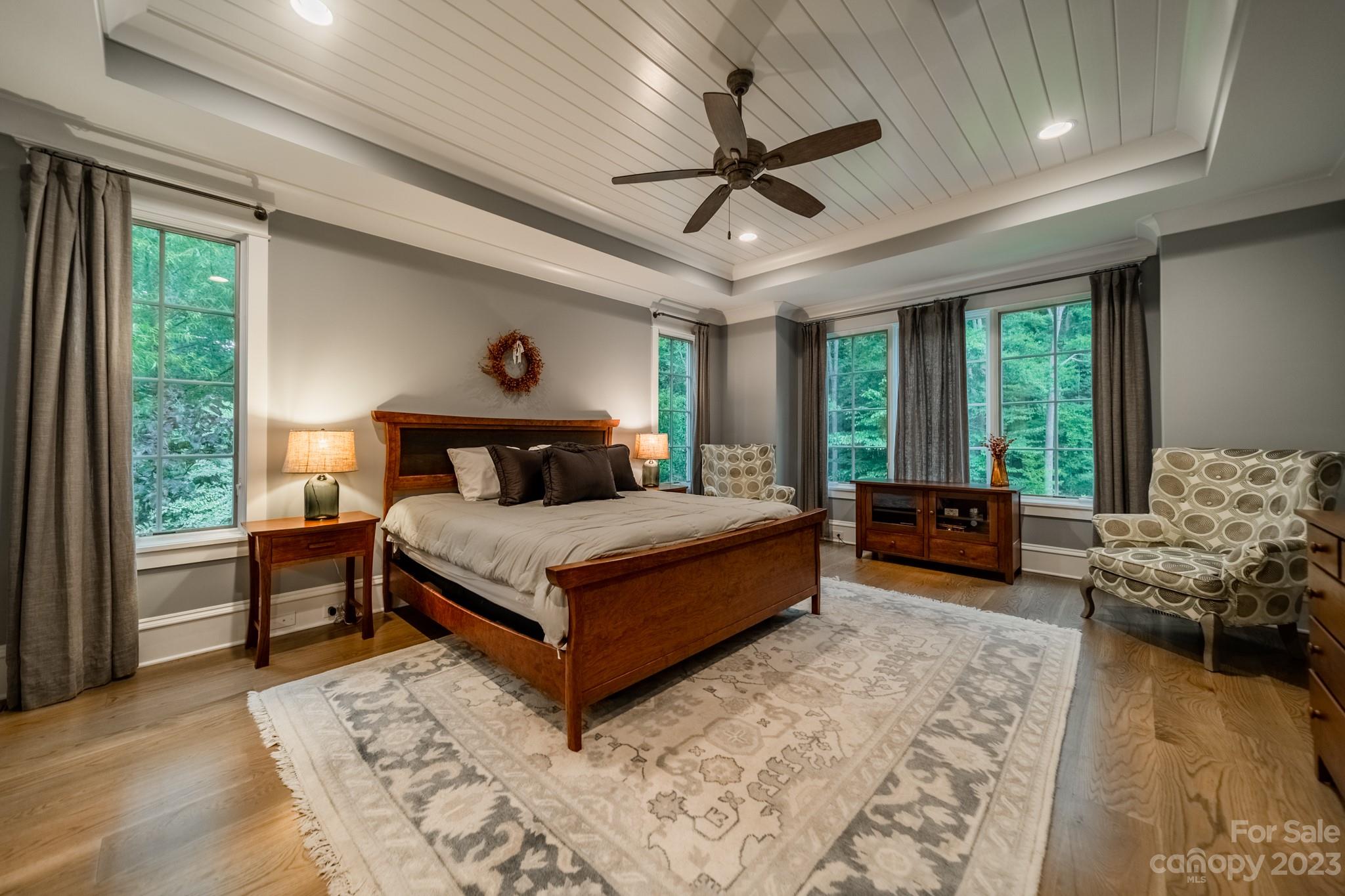 721 Lester Davis Road Waxhaw, NC 28173 - Photo 7 of 48 a bedroom with a large bed and a chandelier