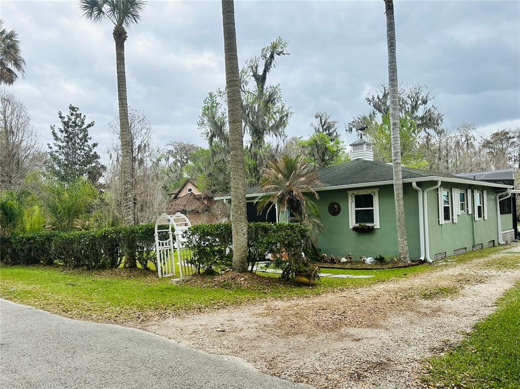 357 Magnolia Place DeBary, FL 32713 - Photo 1 of 50 a front view of a house with garden