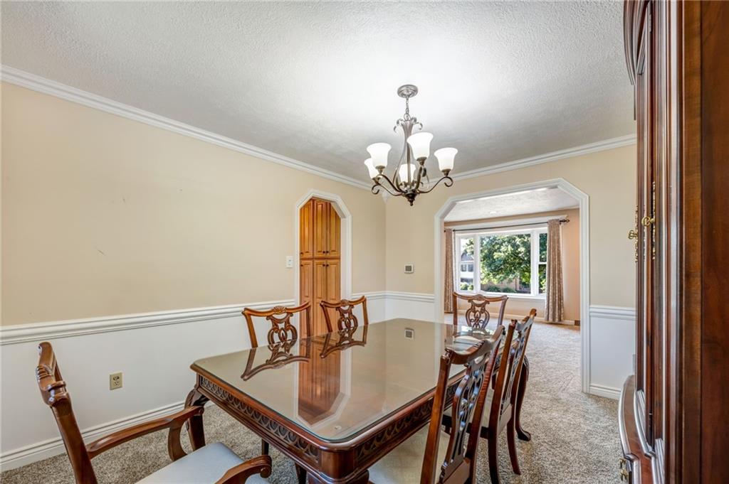 5015 Julia Lane McKees Rocks, PA 15136 - Photo 16 of 45 a view of a dining room with furniture and a chandelier