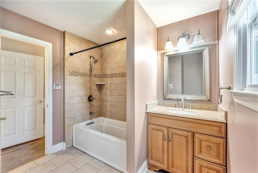 5015 Julia Lane McKees Rocks, PA 15136 - Photo 26 of 45 a bathroom with a bathtub sink vanity and mirror