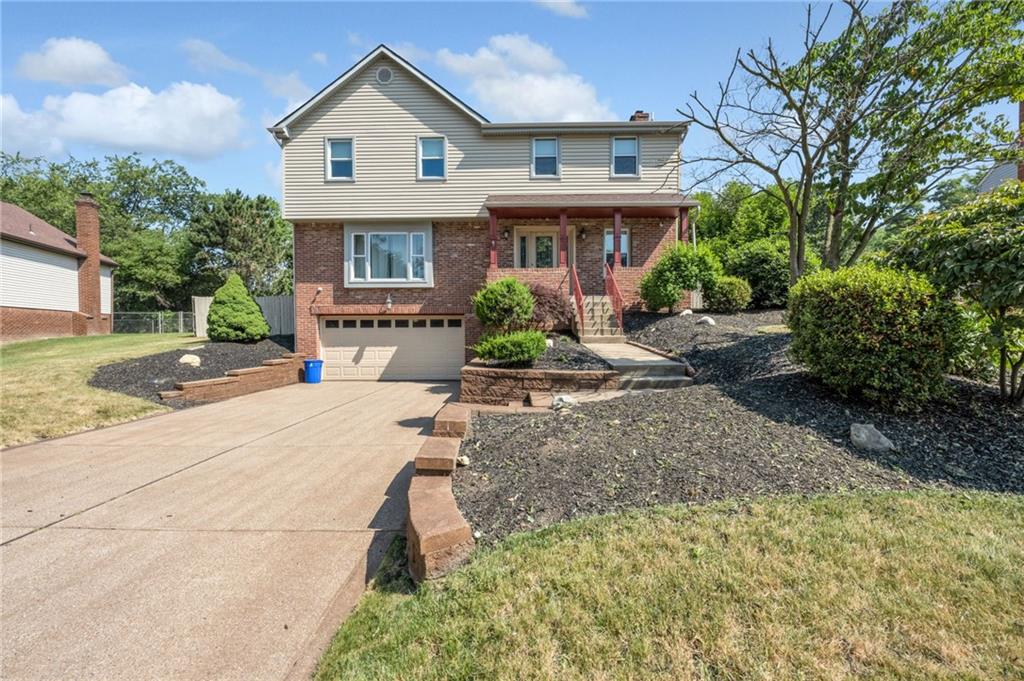 5015 Julia Lane McKees Rocks, PA 15136 - Photo 45 of 45 a front view of a house with a yard and potted plants