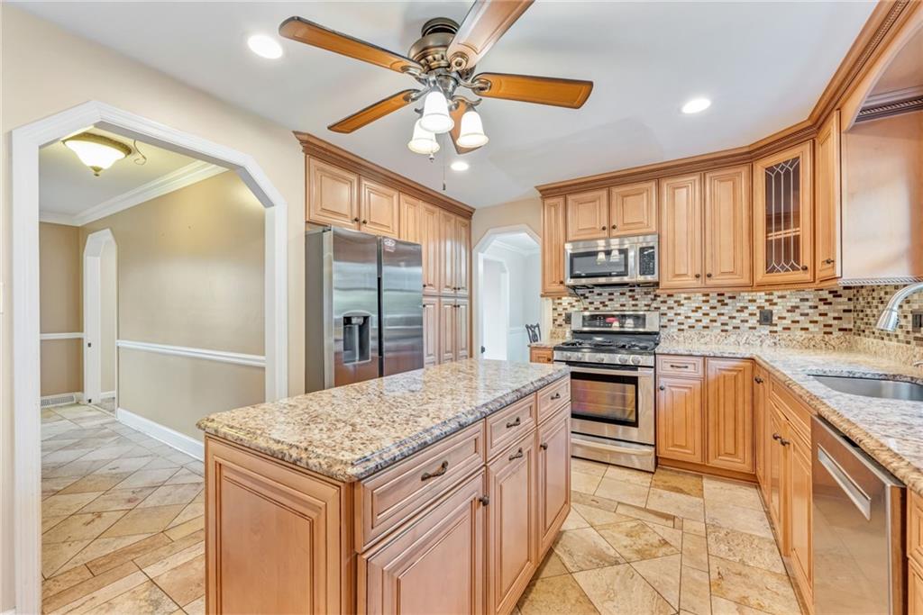 5015 Julia Lane McKees Rocks, PA 15136 - Photo 6 of 45 a kitchen with stainless steel appliances granite countertop a stove cabinets and entryway