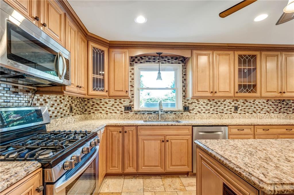 5015 Julia Lane McKees Rocks, PA 15136 - Photo 9 of 45 a kitchen with granite countertop a sink stove and cabinets
