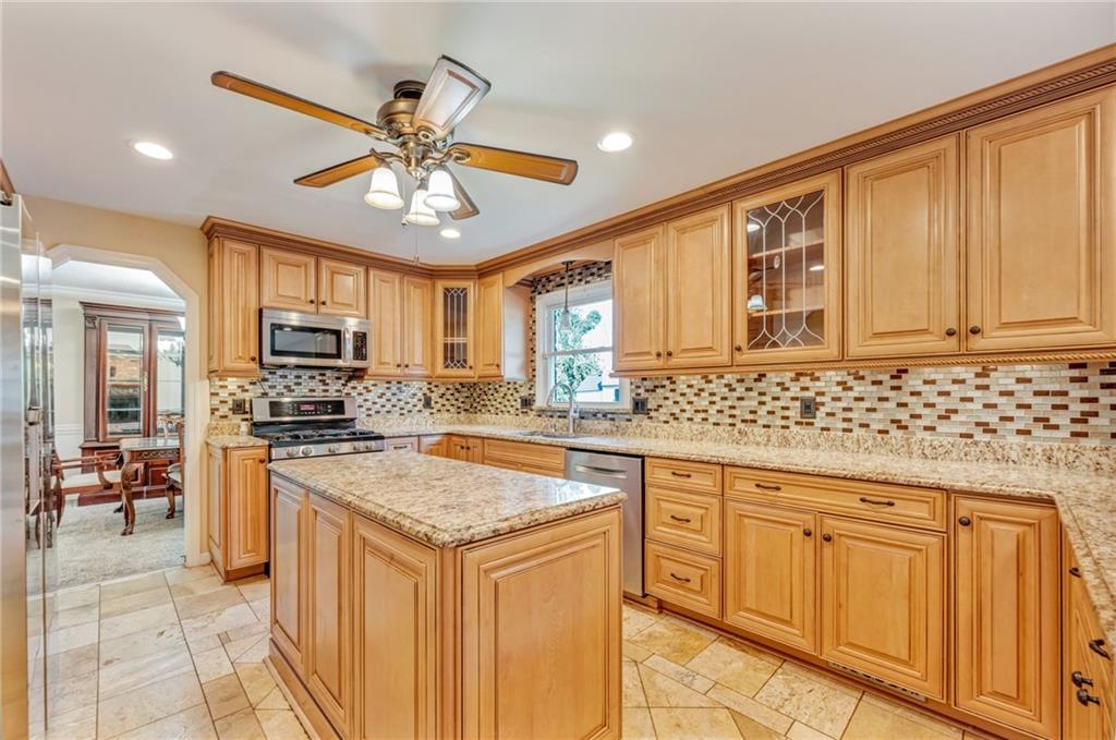 5015 Julia Lane McKees Rocks, PA 15136 - Photo 10 of 45 a kitchen with stainless steel appliances granite countertop a stove refrigerator sink and microwave