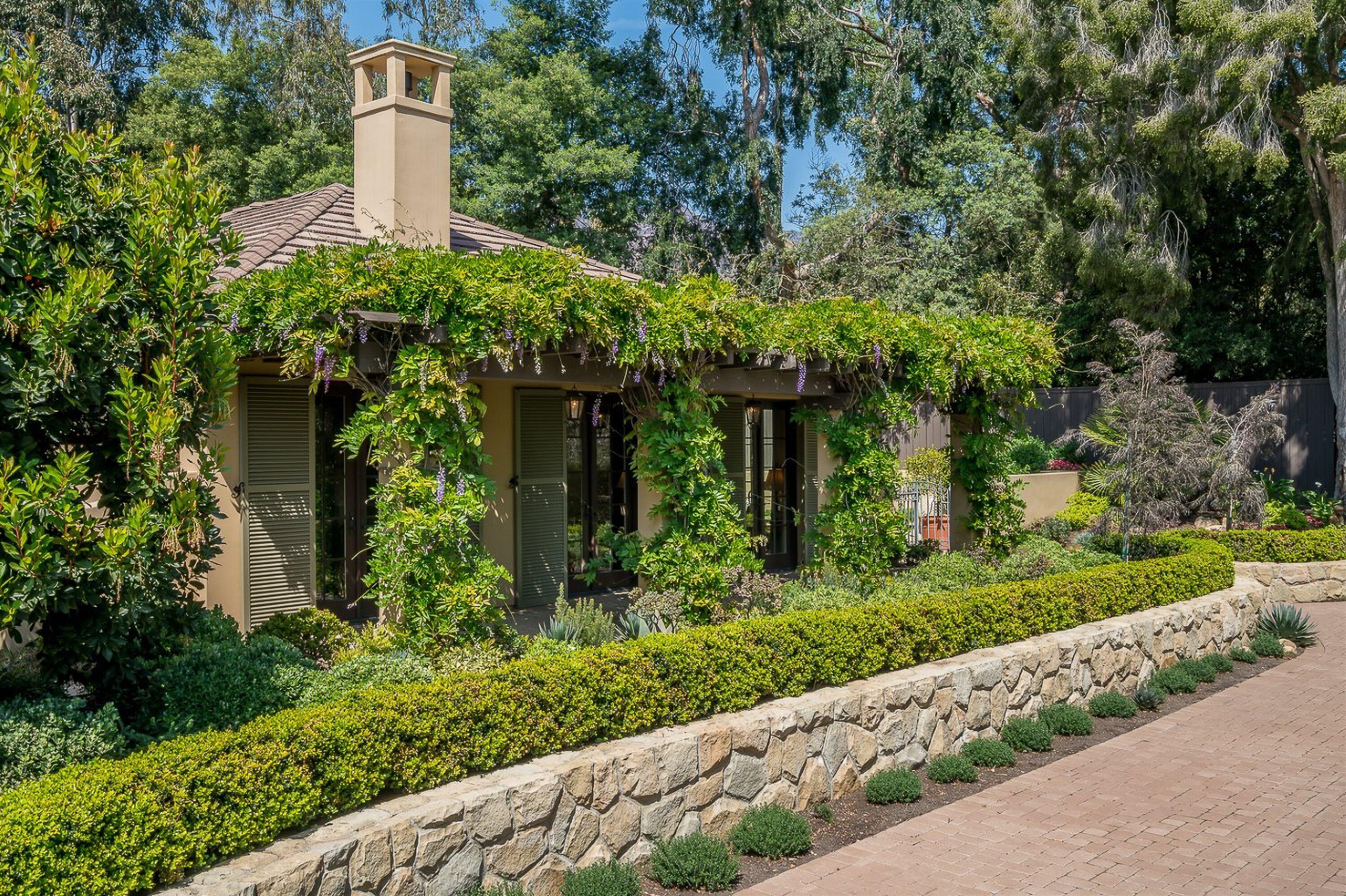 741 Hot Springs Road Santa Barbara, CA 93108 - Photo 3 of 24 a front view of a house with a yard and trees