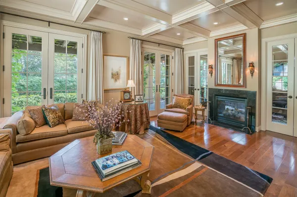 a living room with lots of furniture and a large window