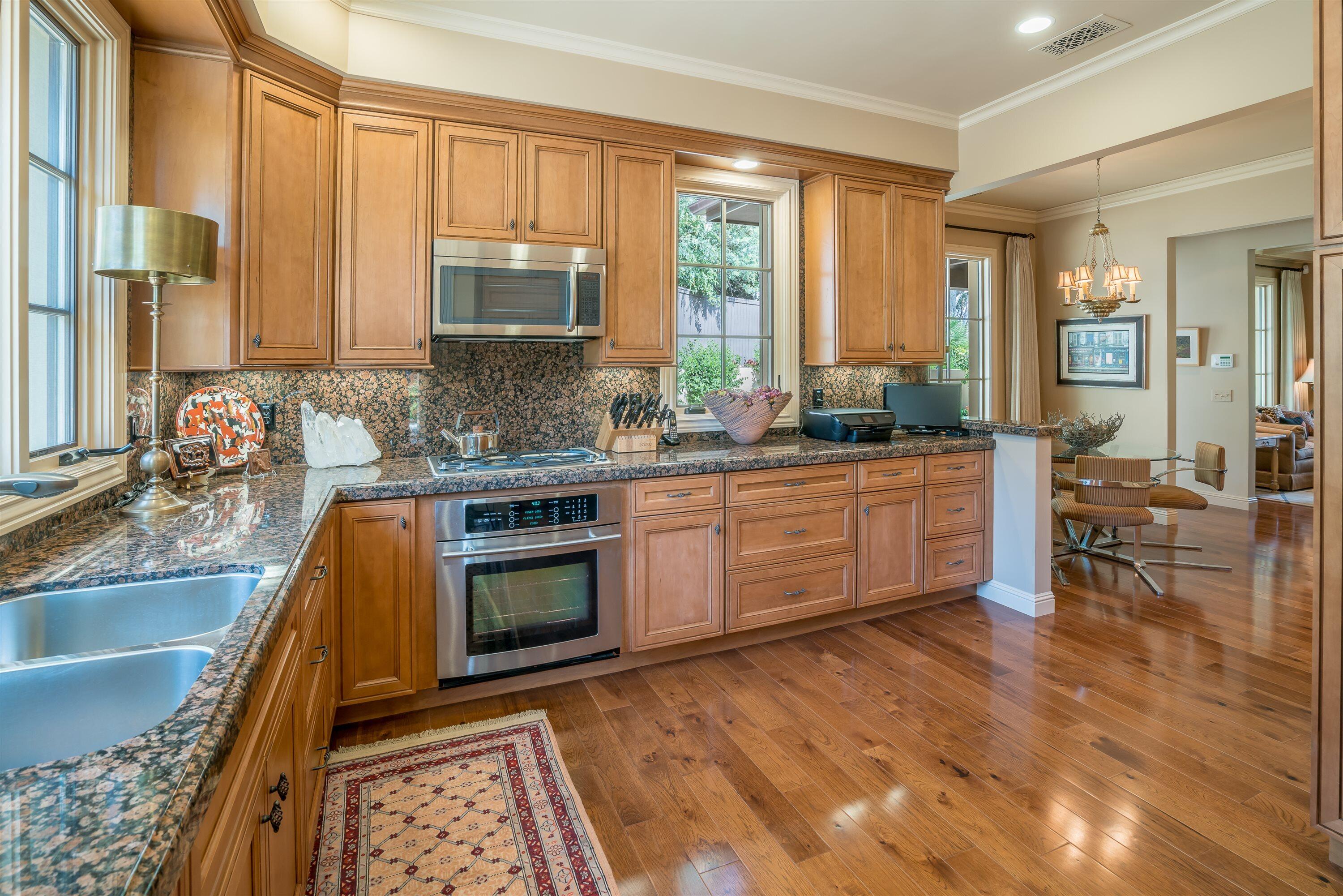 741 Hot Springs Road Santa Barbara, CA 93108 - Photo 9 of 24 a kitchen with stainless steel appliances granite countertop a stove a sink and a microwave