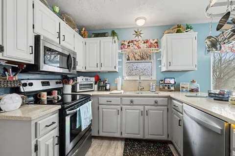 a kitchen with a sink stove and cabinets