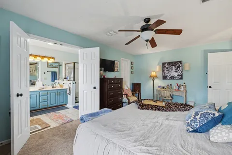 a bedroom with a bed and a chandelier