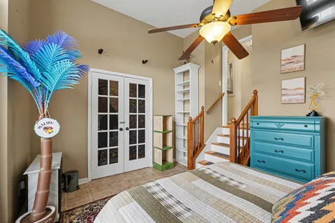 a bedroom with a bed and a chandelier