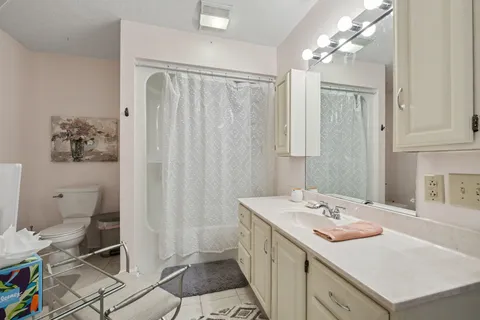 a bathroom with a sink toilet and shower