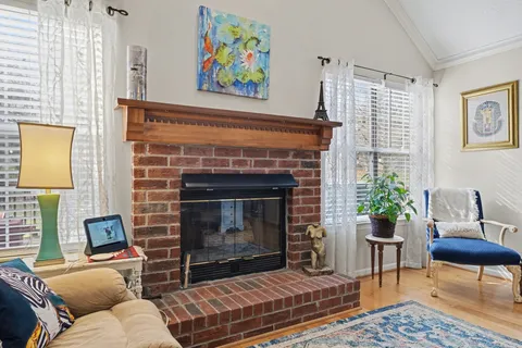 a living room with furniture a rug and a fireplace