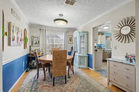 a dining room with furniture and window