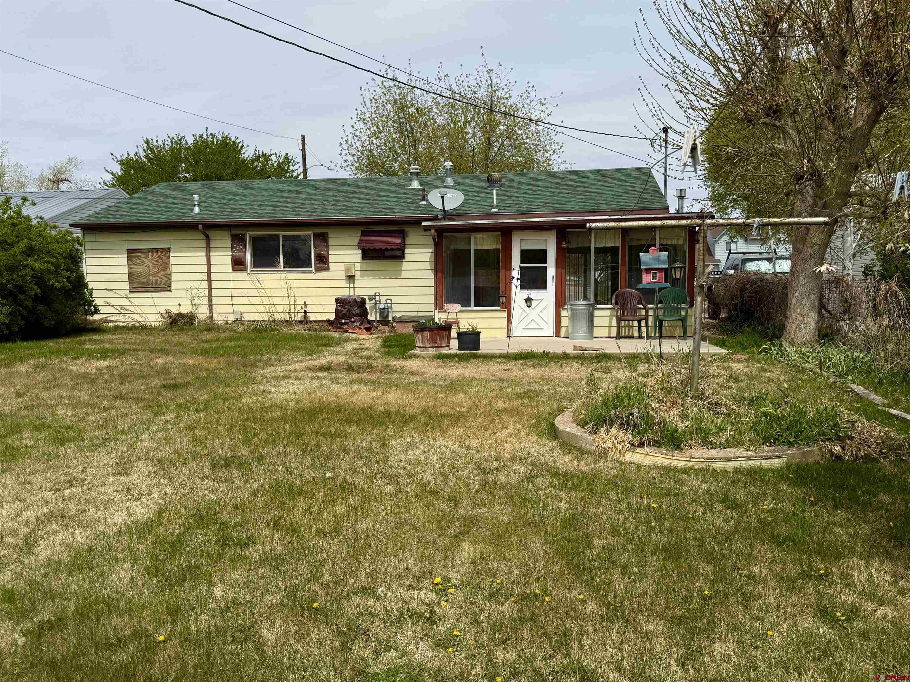 609 East 2nd Street Cortez, CO 81321 - Photo 16 of 21 a backyard of a house with yard table and chairs