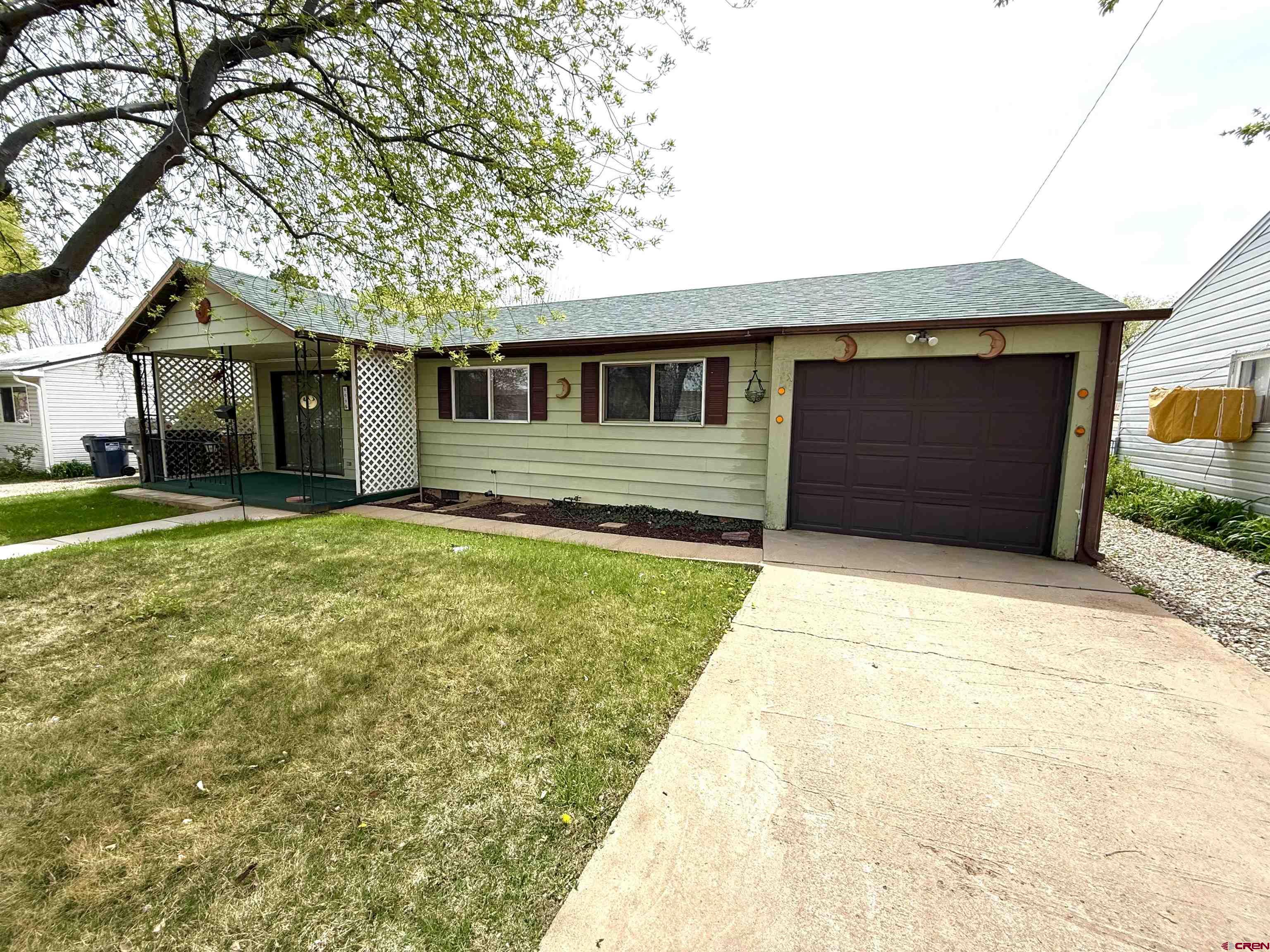 609 East 2nd Street Cortez, CO 81321 - Photo 2 of 21 a front view of a house with a yard and garage