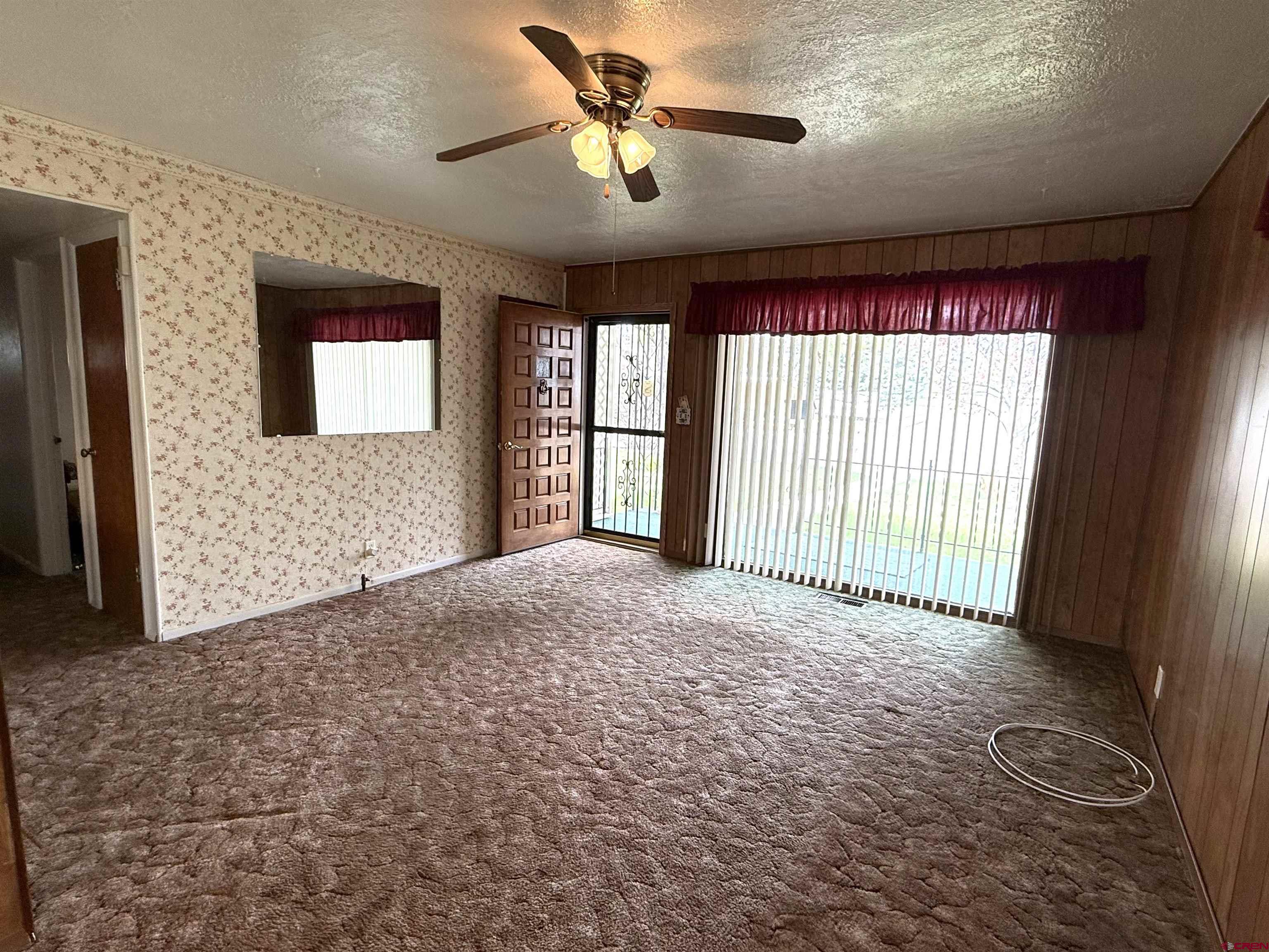 609 East 2nd Street Cortez, CO 81321 - Photo 3 of 21 a view of empty room with a ceiling fan and window