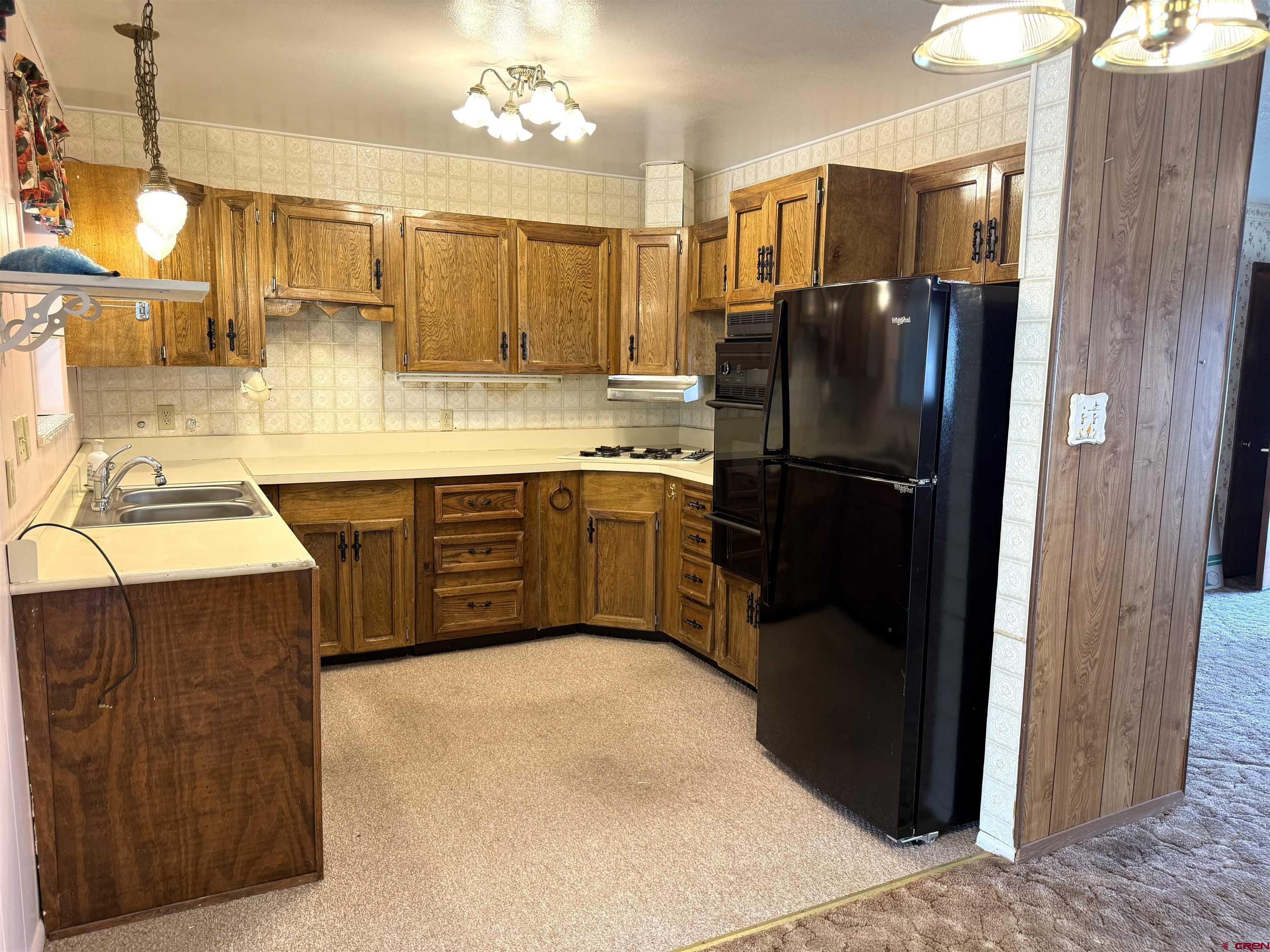 609 East 2nd Street Cortez, CO 81321 - Photo 6 of 21 a kitchen with a sink appliances and cabinets