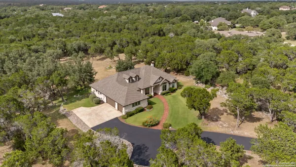 an aerial view of a house with yard