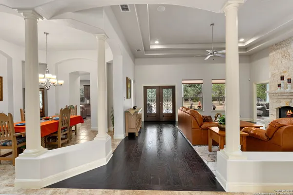 a living room with furniture and a chandelier