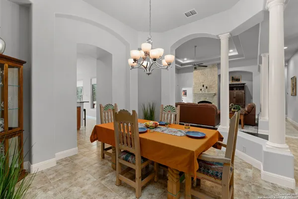 a view of a dining room with furniture and chandelier