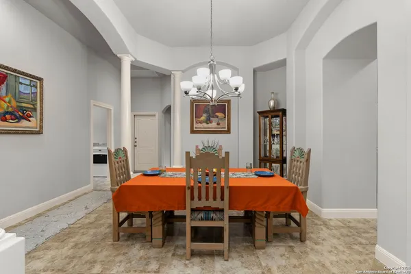 a view of a dining room with furniture and chandelier