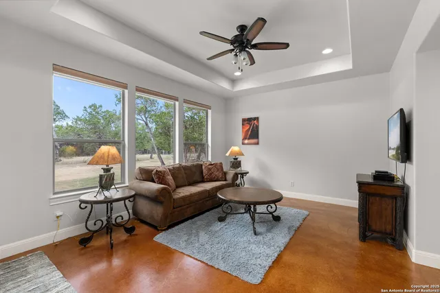 a living room with furniture and a large window