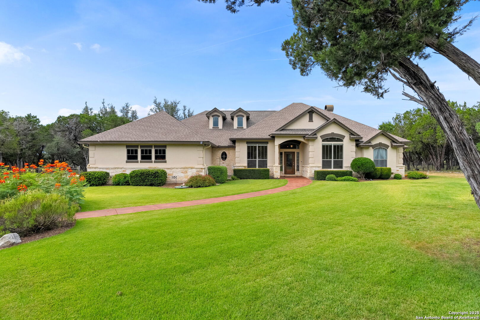 2956 Rio Cordillera Boerne, TX 78006 - Photo 2 of 41 a front view of a house with a garden