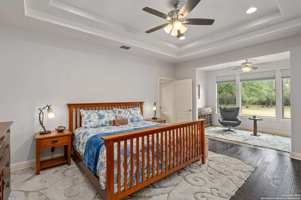 a bedroom with furniture and a large window