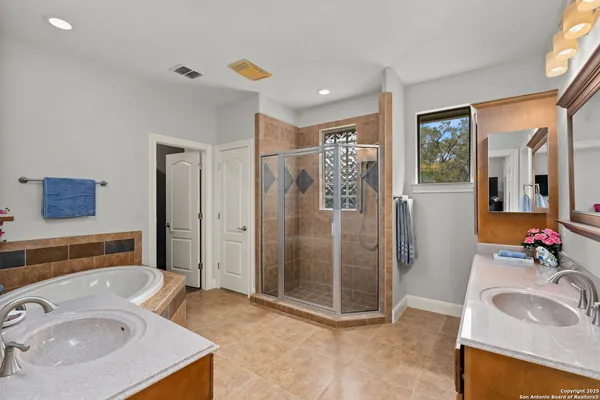 a bathroom with a sink double vanity and a shower