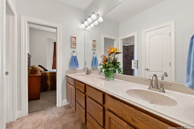 a bathroom with a sink double vanity and a mirror