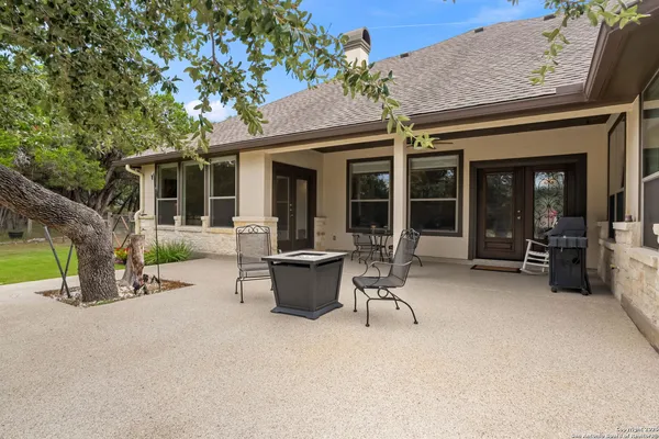 a view of a house with patio and a garden