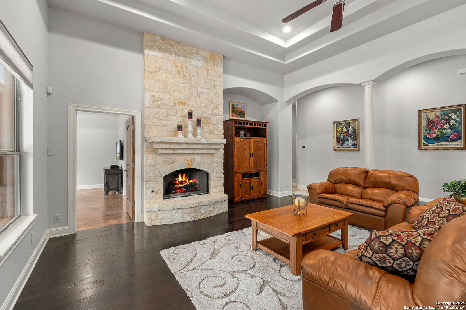 2956 Rio Cordillera Boerne, TX 78006 - Photo 7 of 41 a living room with furniture a fireplace and a large window