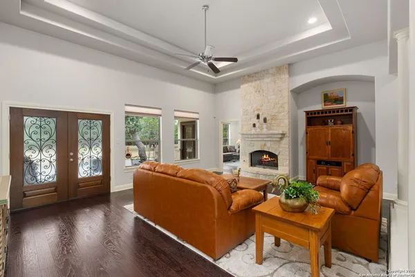 a living room with furniture a large window and a fireplace