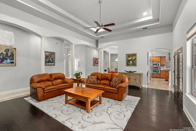 a living room with furniture ceiling fan and a rug