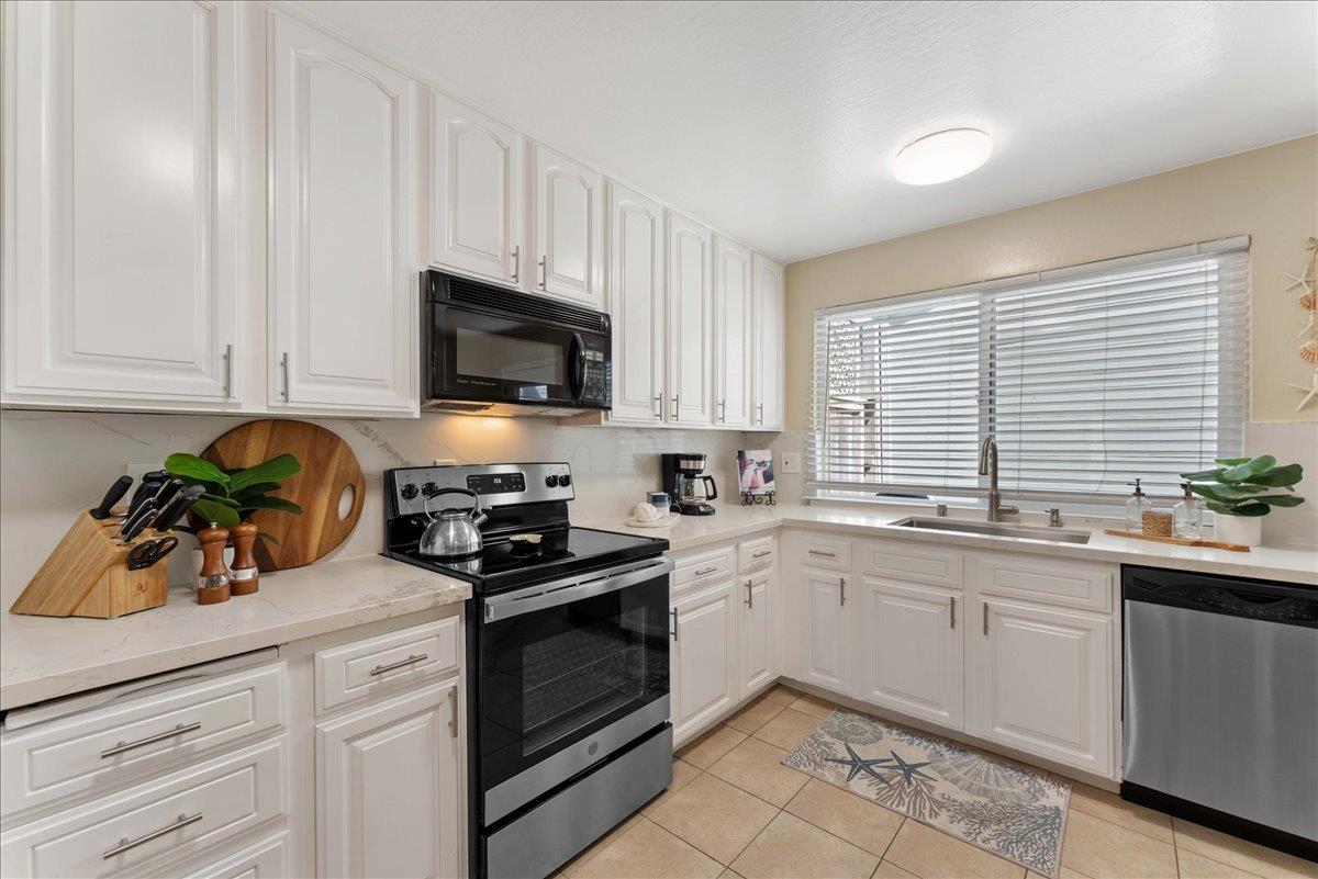 208 Stockton Avenue Capitola, CA 95010 - Photo 11 of 36 a kitchen with appliances a sink and cabinets