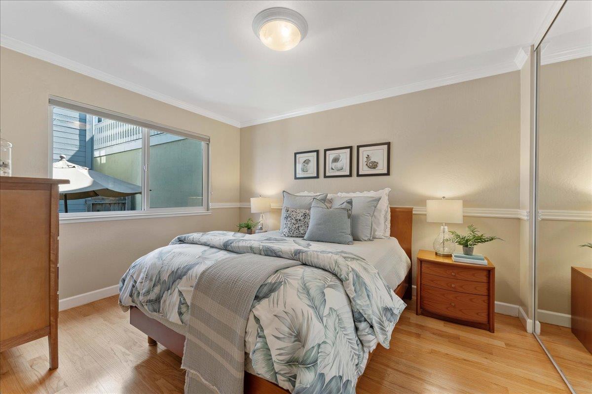 208 Stockton Avenue Capitola, CA 95010 - Photo 13 of 36 a bedroom with a bed and a large window