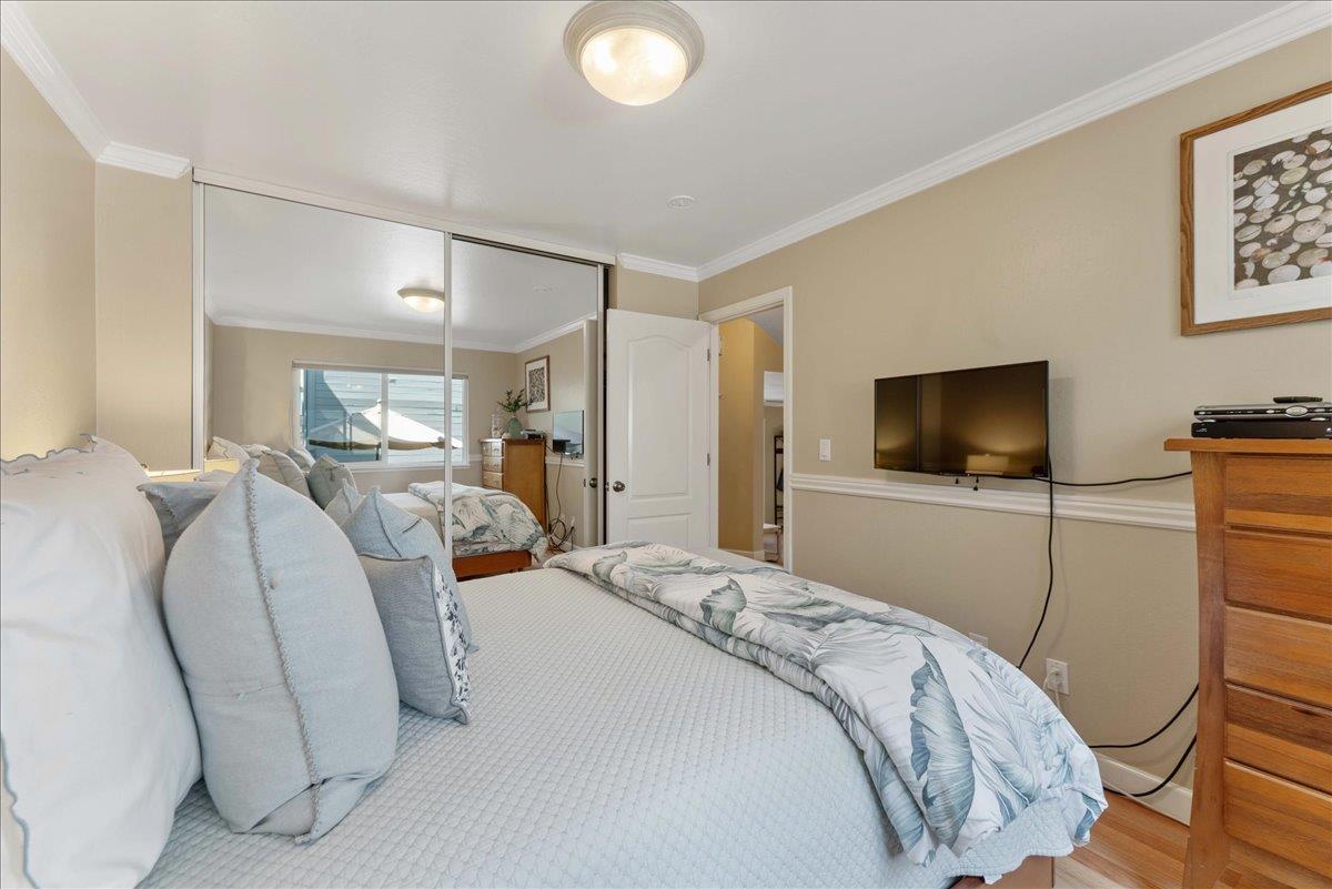 208 Stockton Avenue Capitola, CA 95010 - Photo 14 of 36 a bedroom with a bed and a flat screen tv