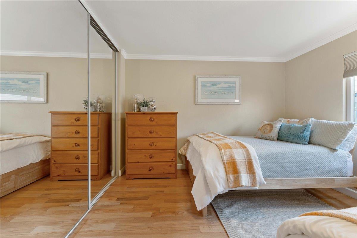 208 Stockton Avenue Capitola, CA 95010 - Photo 16 of 36 a bedroom with a bed and a cabinets