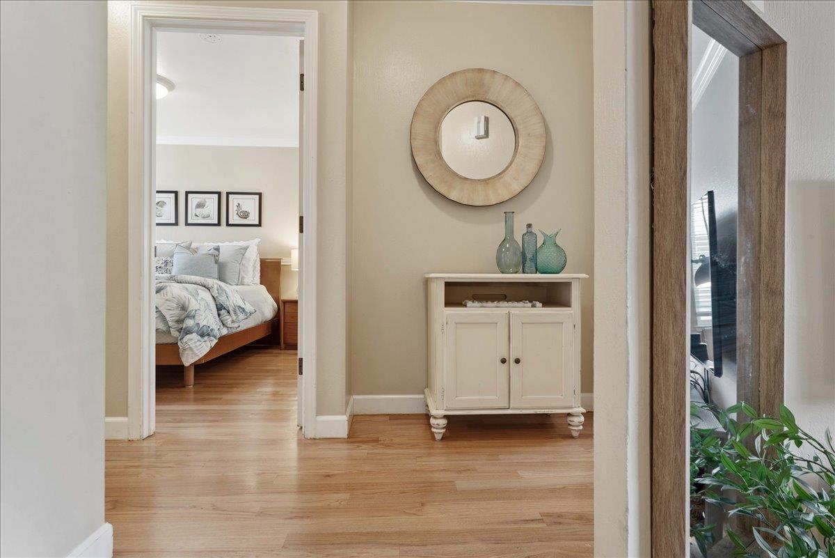 208 Stockton Avenue Capitola, CA 95010 - Photo 17 of 36 a view of a bedroom with a bed wooden floor and mirror