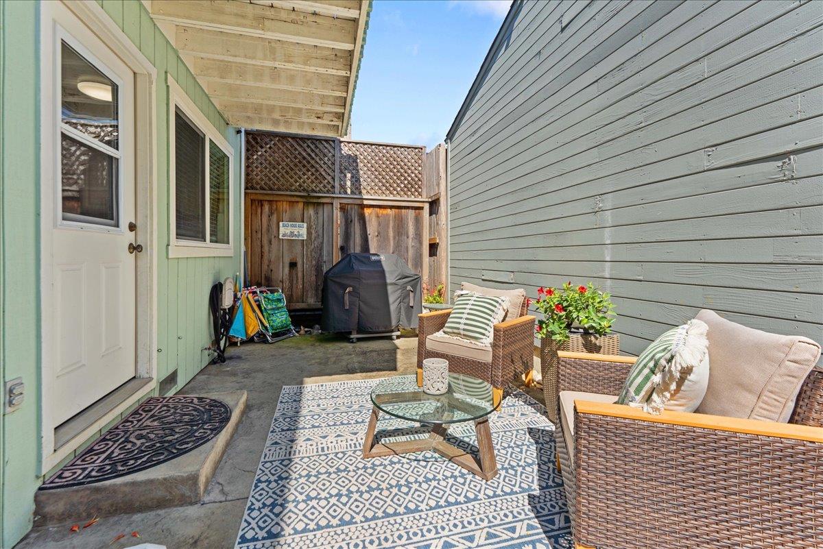 208 Stockton Avenue Capitola, CA 95010 - Photo 20 of 36 a view of a patio with a table and chairs and wooden floor
