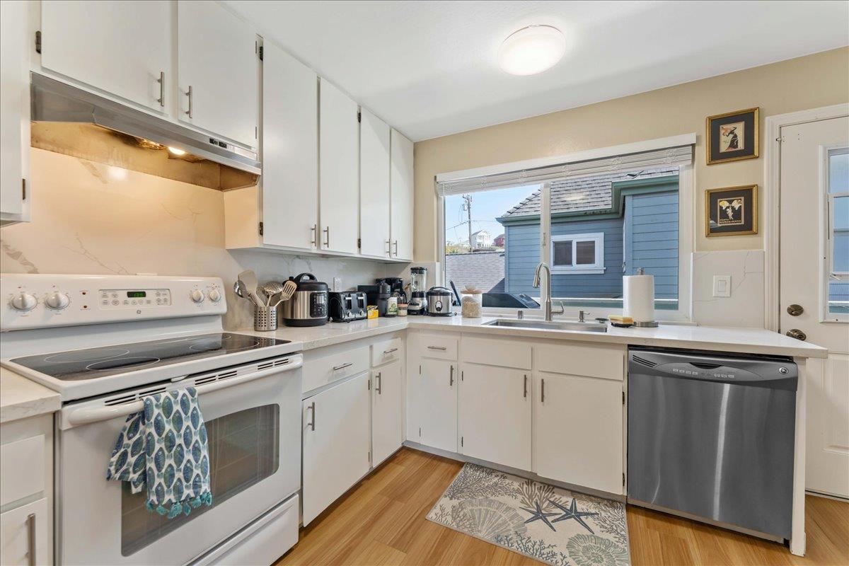 208 Stockton Avenue Capitola, CA 95010 - Photo 25 of 36 a kitchen with stainless steel appliances granite countertop a stove a sink and a microwave