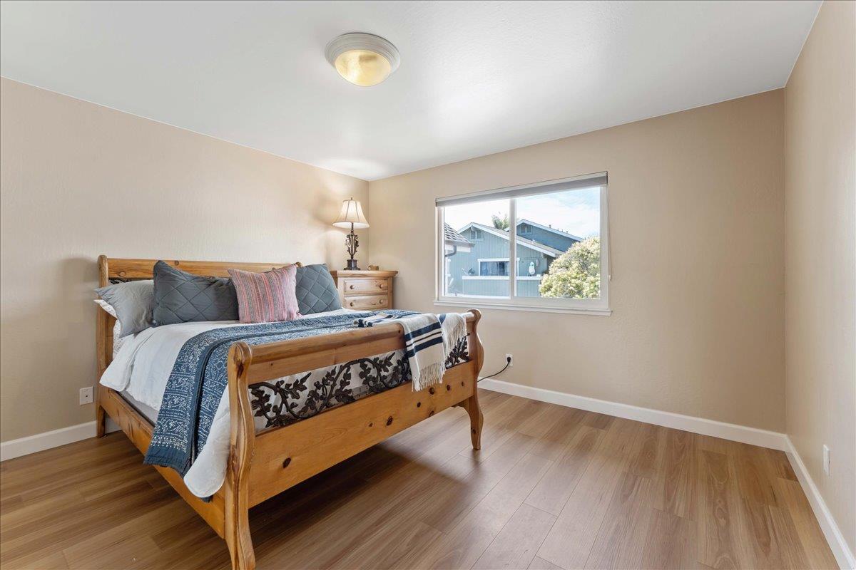 208 Stockton Avenue Capitola, CA 95010 - Photo 27 of 36 a bedroom with a bed and window
