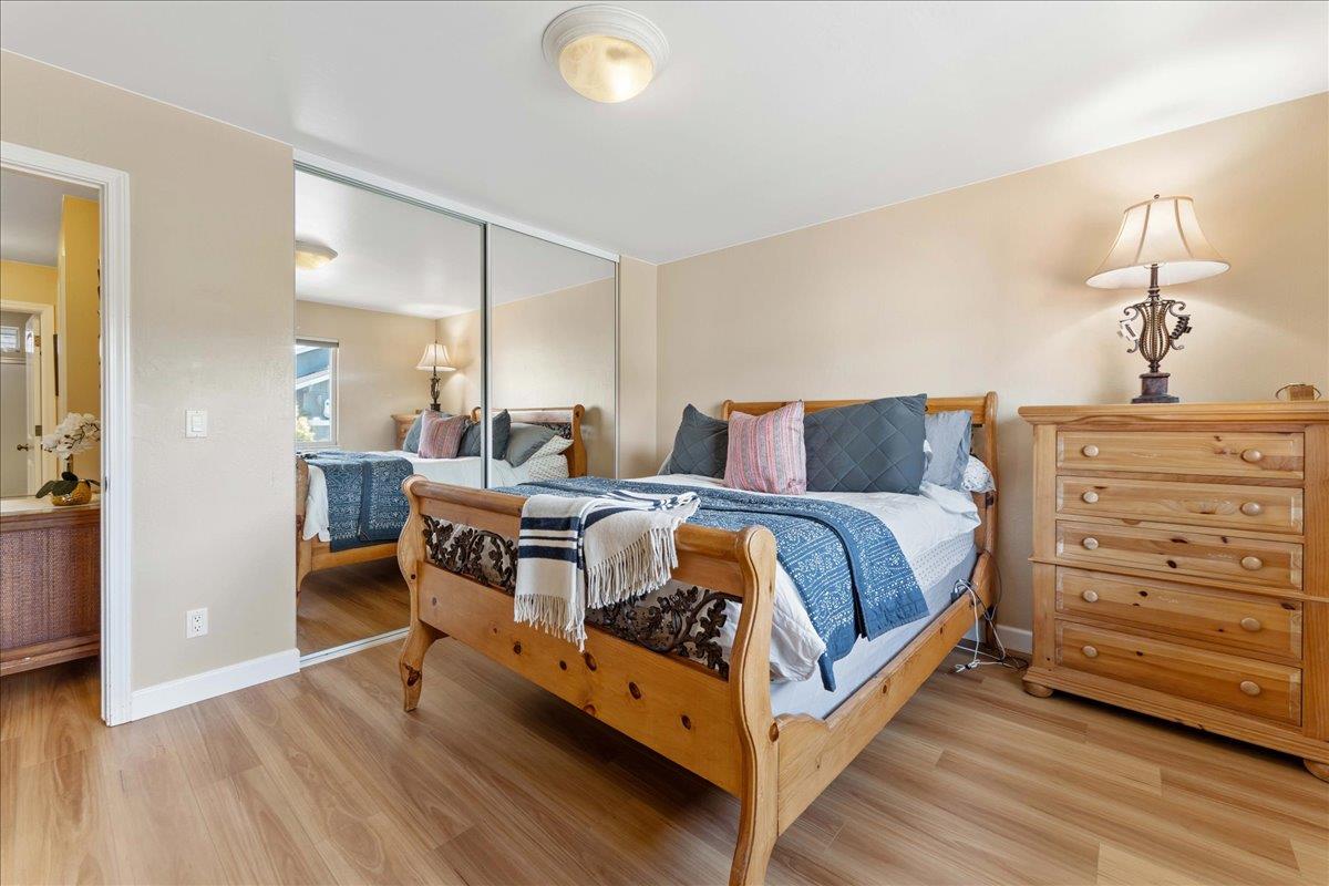 208 Stockton Avenue Capitola, CA 95010 - Photo 28 of 36 a bedroom with a bed and a dresser