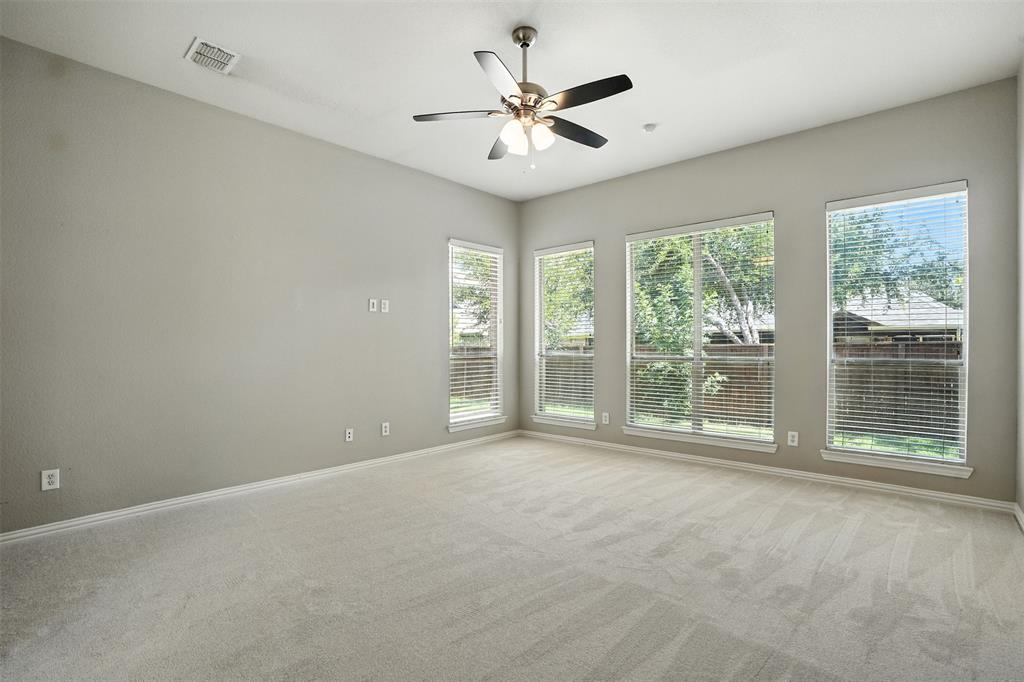 8220 Holliday Road Lantana, TX 76226 - Photo 18 of 40 Spacious room with light-toned carpeting and neutral wall paint