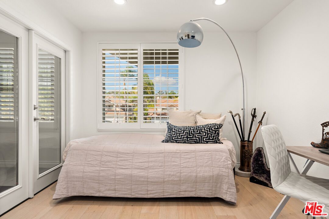 24762 Vía Pradera Calabasas, CA 91302 - Photo 19 of 29 a bedroom with a bed and potted plant with two large window