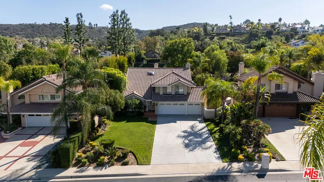 a aerial view of residential houses with yard